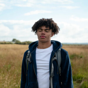 young man practicing self-care in nature