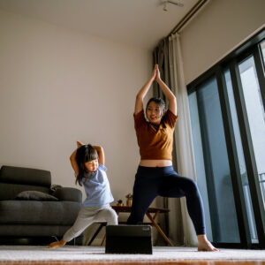 women and daughter doing yoga